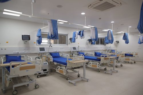 Well-equipped hospital ward at Care and Cure Hospital with multiple patient beds and medical facilities.