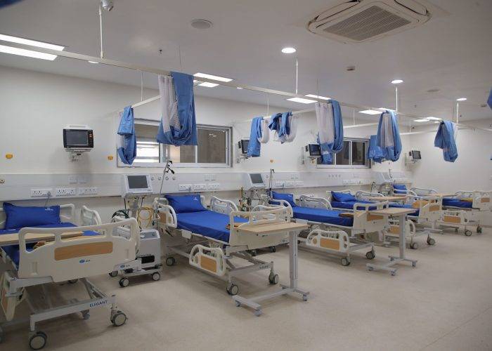 Well-equipped hospital ward at Care and Cure Hospital with multiple patient beds and medical facilities.